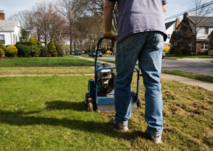 Neighborhood Lawn Care in Vancouver, WA.  Dethatching a front lawn